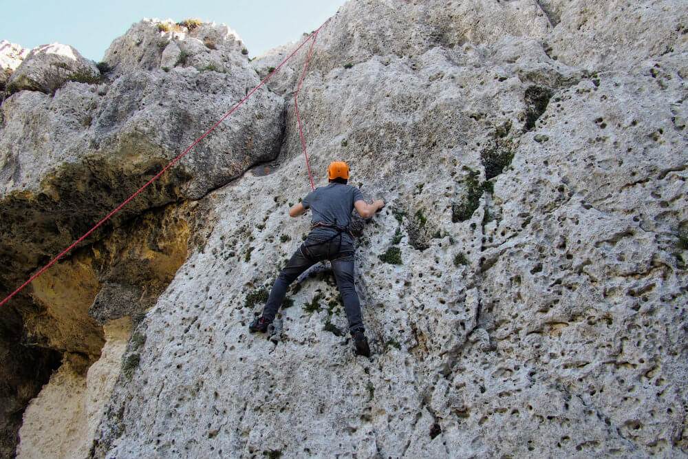 Matt scales one of three 30 metre high climbs near Mġarr ix-Xini, Gozo