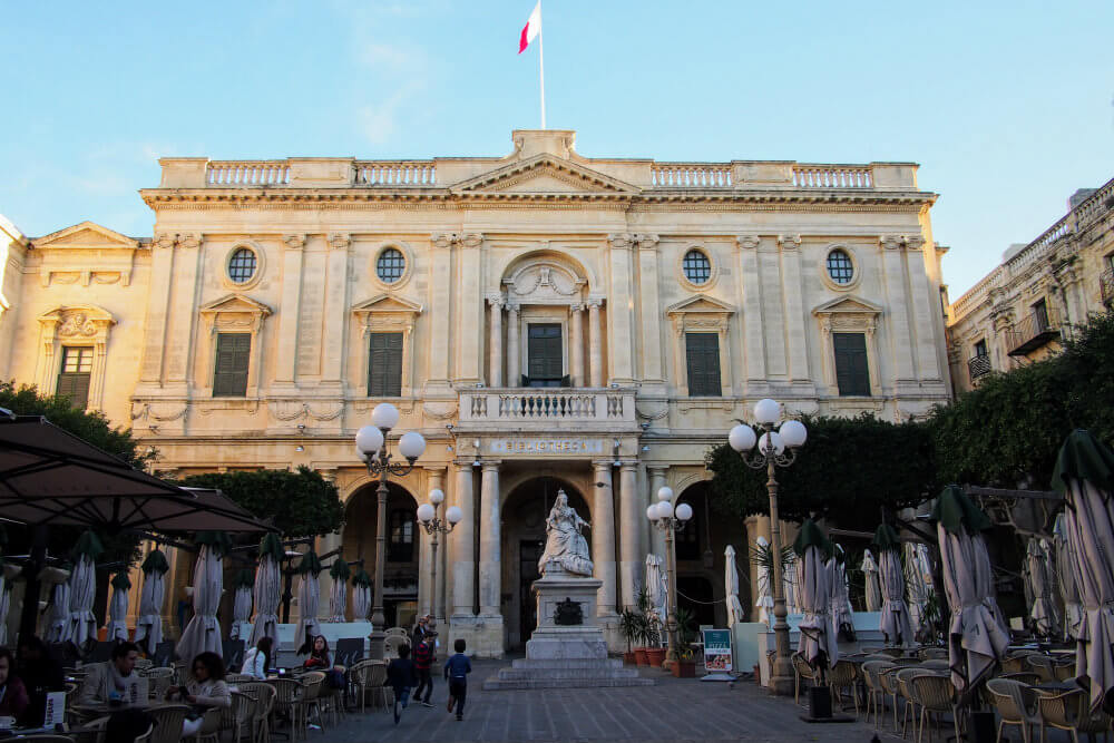 The National Library of Malta in the background with outdoor seating for Caffe Cordina on the square