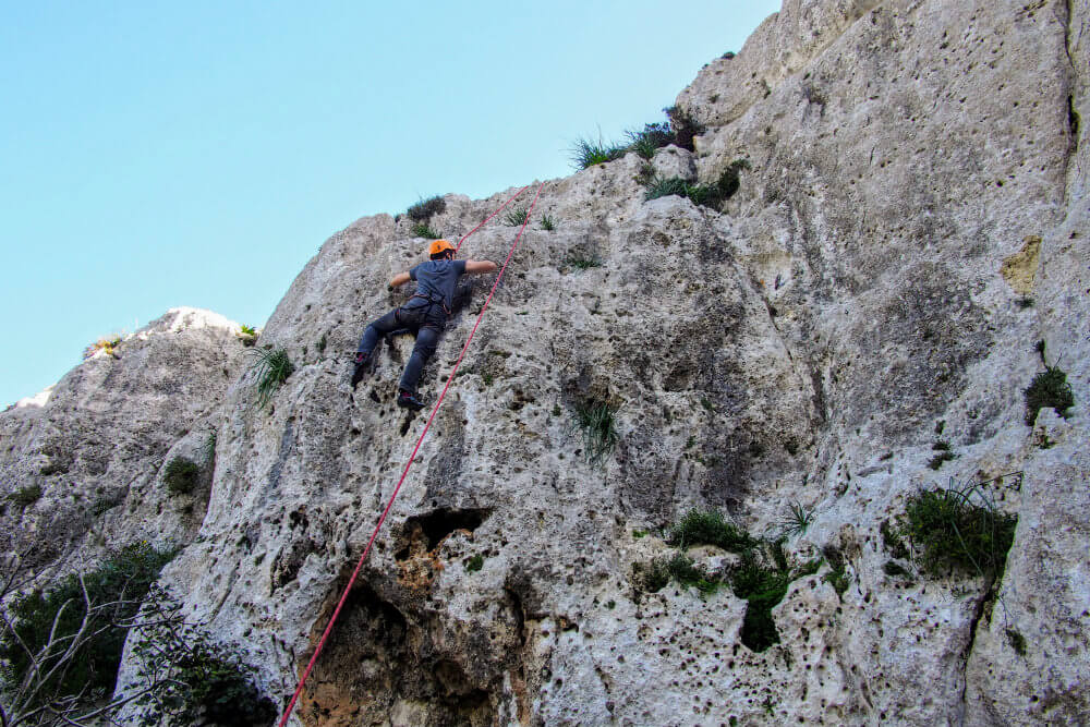 Matt scales the third of three climbs during our climbing in Gozo experience