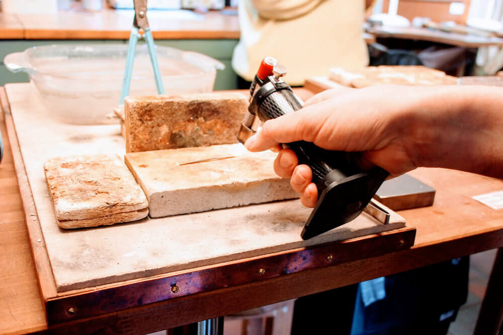 Warming the gold bar with a blowtorch (annealing) makes the bar malleable.