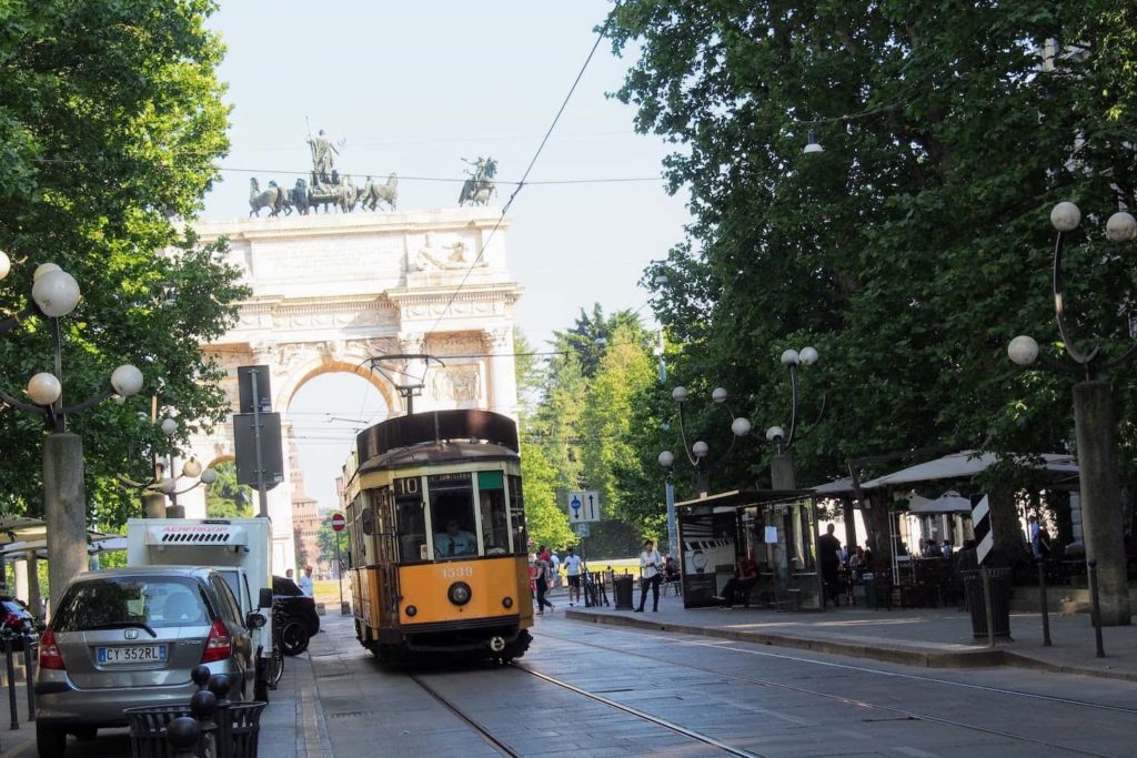 A tram run along Corso Sempione in front of Arco della Pace in Milan, Italy