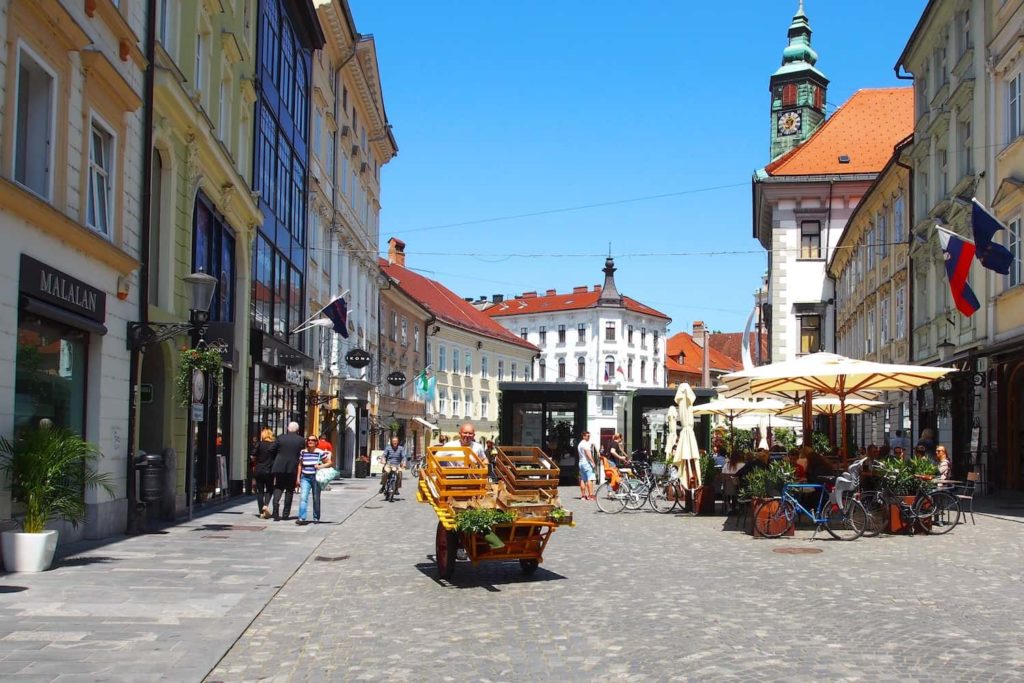 A trader pushes a cart through central Ljubljana, Slovenia