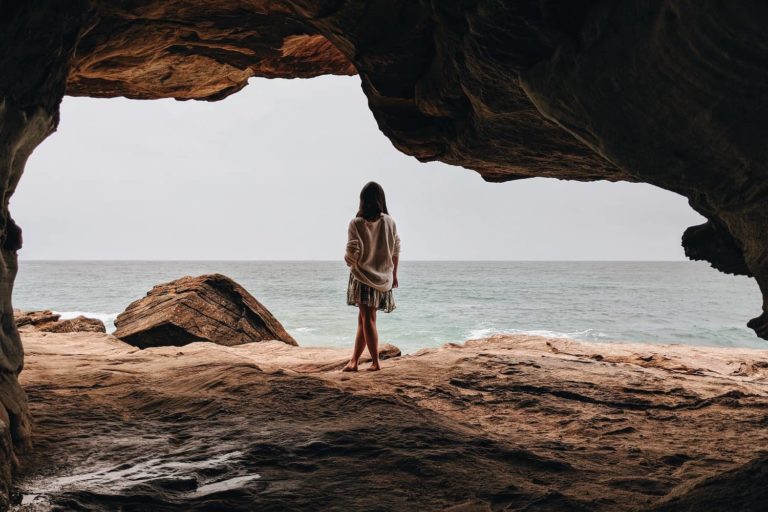 A person stands amidst a cave in Manly, Australia