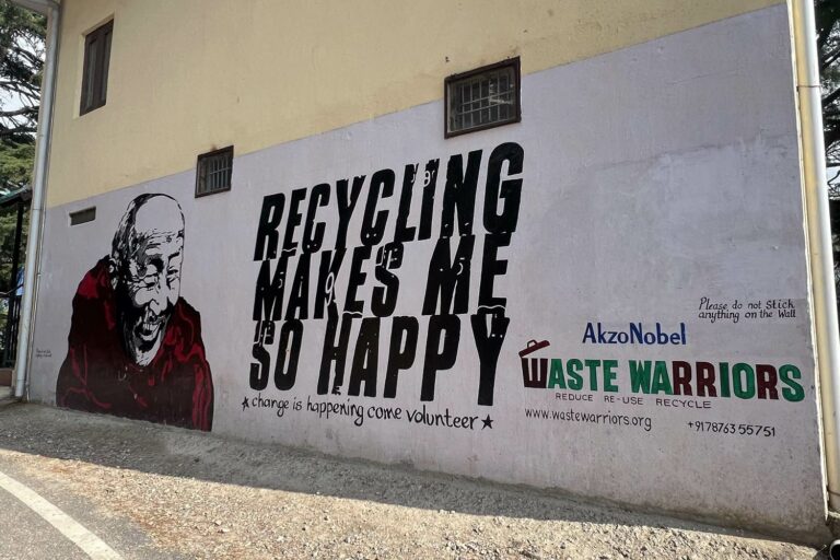 Street in in Dharamshala, India featuring the Dalai Lama encouraging recycling