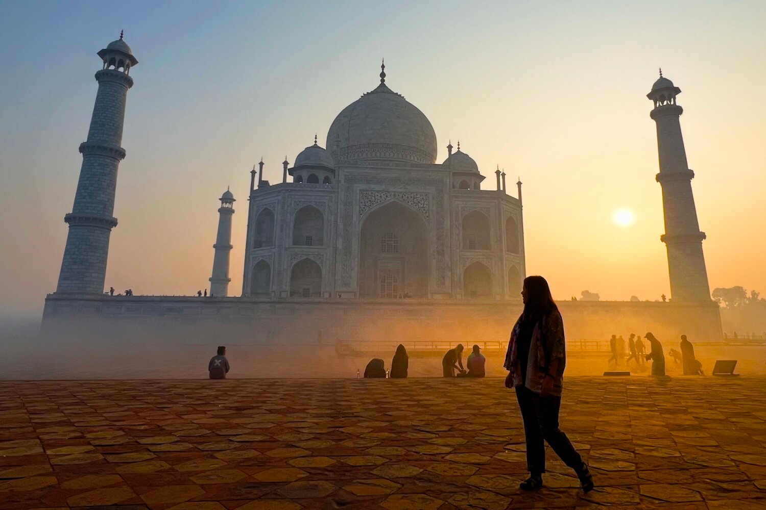 Jade walks by as the sun rises over the Taj Mahal in Agra, India